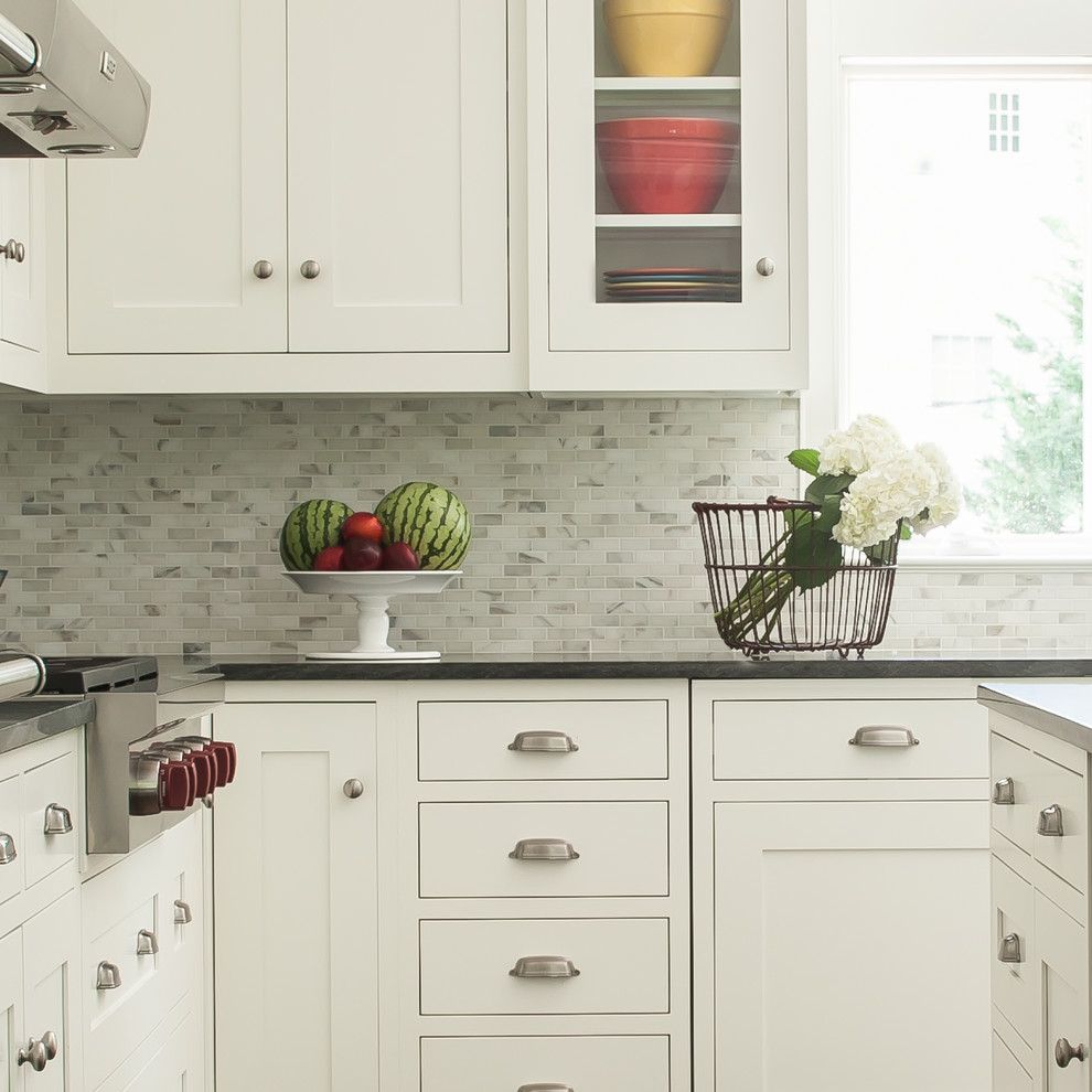 Elegant kitchen photo in New York with gray backsplash