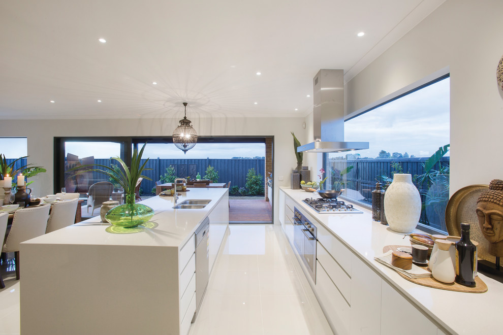 Inspiration for a contemporary open plan kitchen in Melbourne with a double-bowl sink, flat-panel cabinets, white cabinets, stainless steel appliances and an island.