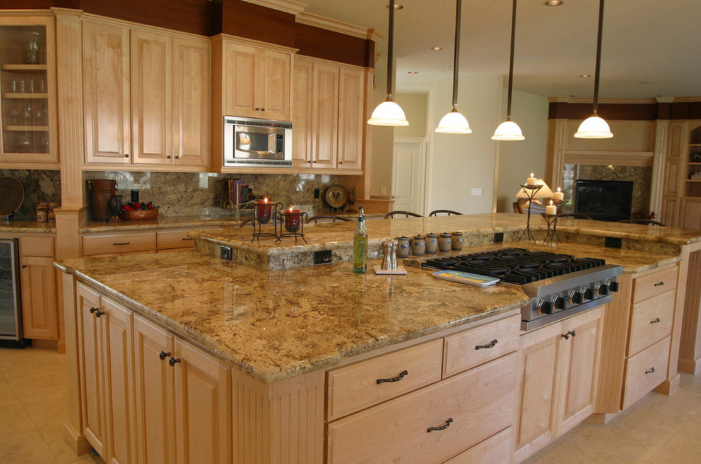 Example of a large classic galley ceramic tile eat-in kitchen design in New York with a drop-in sink, raised-panel cabinets, medium tone wood cabinets, granite countertops, beige backsplash, stainless steel appliances and an island
