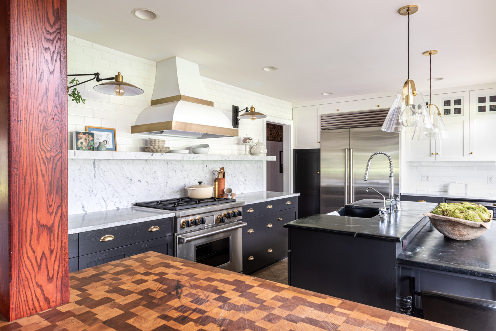 Example of a mid-sized minimalist u-shaped ceramic tile and beige floor eat-in kitchen design in Philadelphia with a triple-bowl sink, flat-panel cabinets, black cabinets, marble countertops, white backsplash, marble backsplash, stainless steel appliances, an island and white countertops