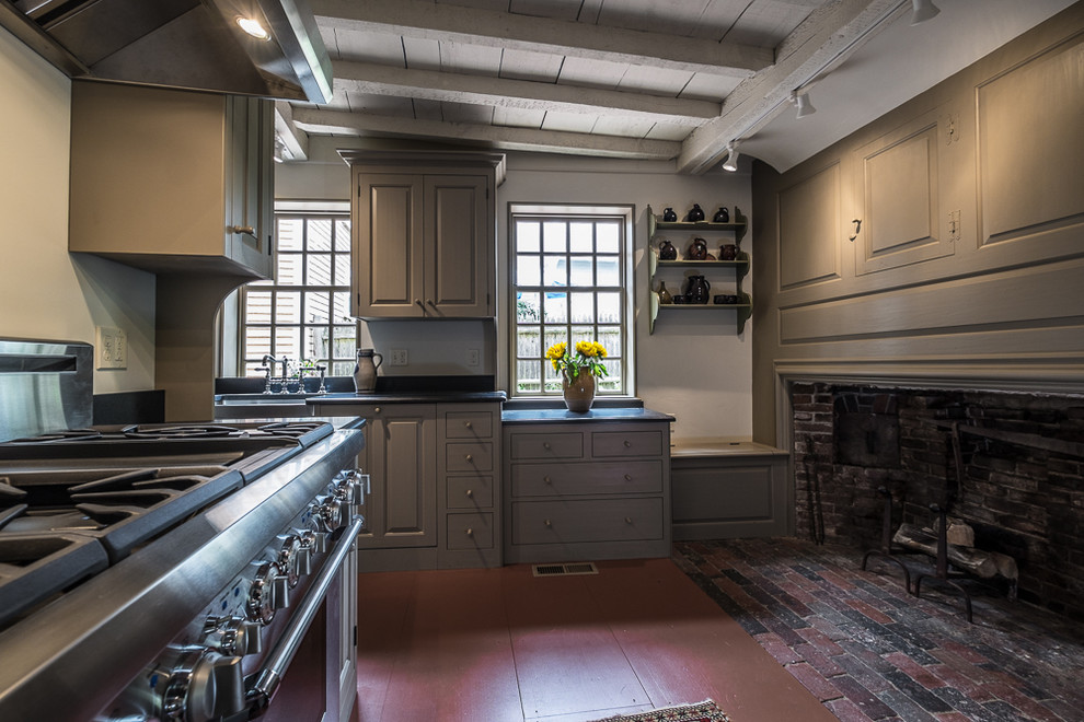 This is an example of a medium sized classic galley enclosed kitchen in Boston with a belfast sink, grey cabinets, stainless steel appliances, painted wood flooring, no island, raised-panel cabinets, granite worktops and beige splashback.