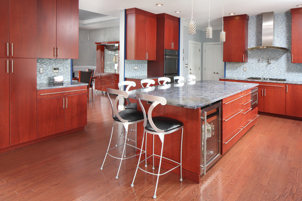 Large trendy u-shaped medium tone wood floor and brown floor eat-in kitchen photo in Boston with an undermount sink, flat-panel cabinets, medium tone wood cabinets, granite countertops, blue backsplash, glass tile backsplash, stainless steel appliances and an island
