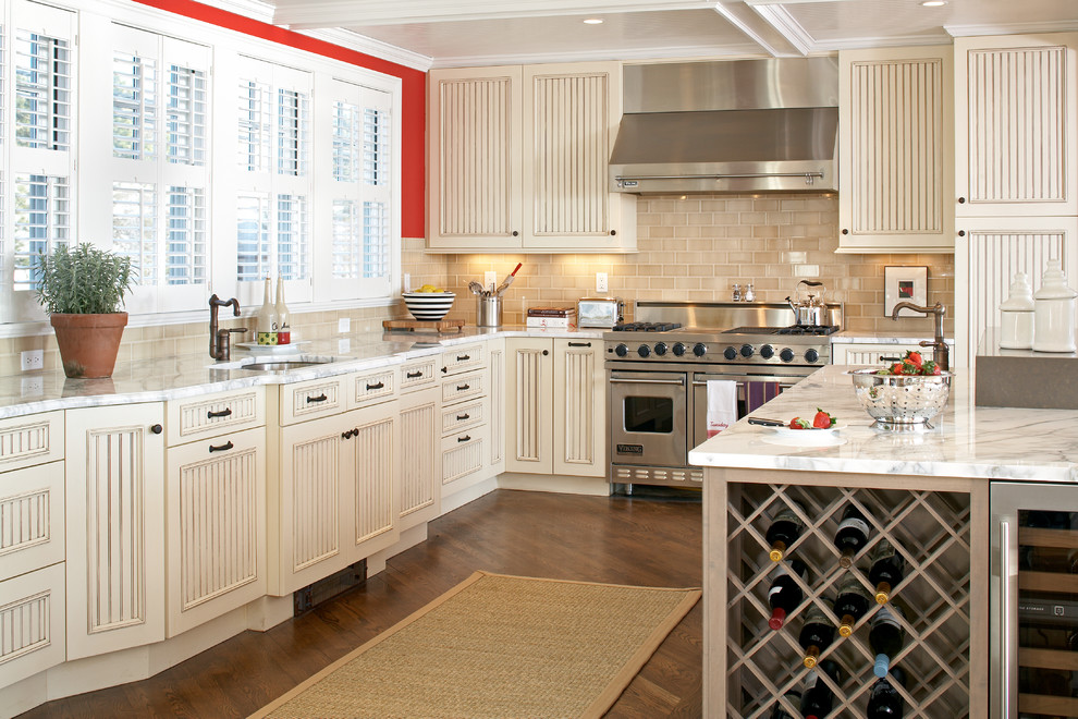 Design ideas for a large nautical l-shaped kitchen in Boston with stainless steel appliances, a submerged sink, distressed cabinets, marble worktops, beige splashback, ceramic splashback, medium hardwood flooring, an island and recessed-panel cabinets.