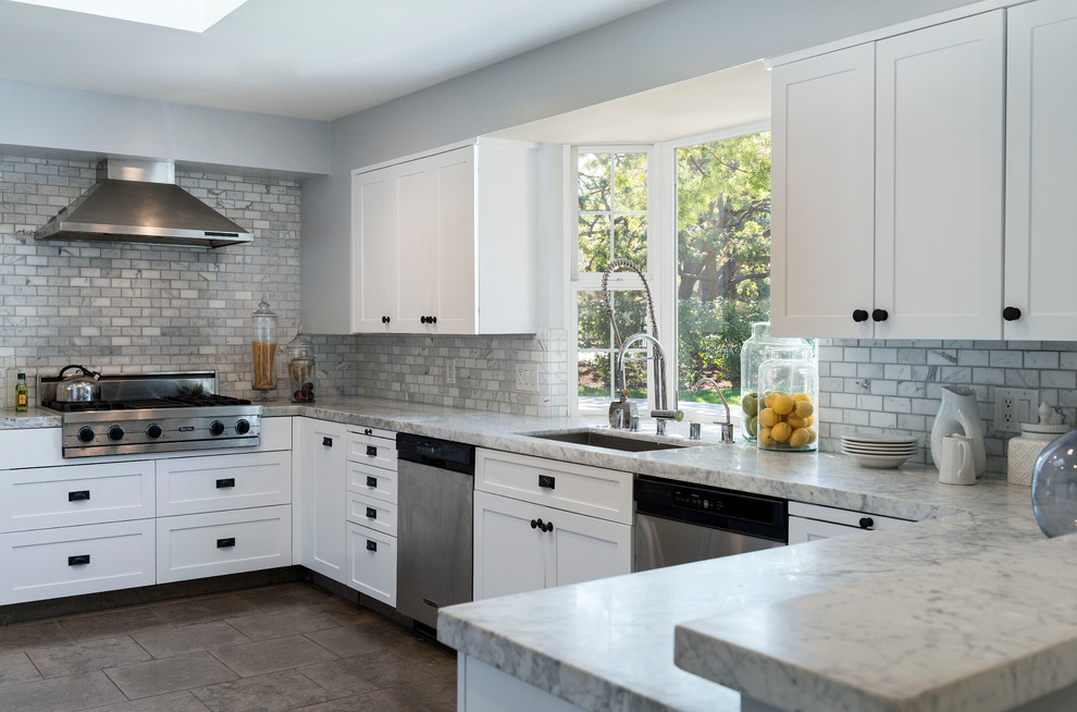 Klassische Küche in U-Form mit Unterbauwaschbecken, Schrankfronten im Shaker-Stil, Küchenrückwand in Weiß, Rückwand aus Steinfliesen und Halbinsel in Los Angeles