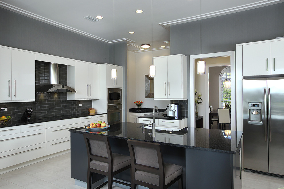 Mid-sized trendy u-shaped porcelain tile kitchen photo in Miami with stainless steel appliances, a farmhouse sink, flat-panel cabinets, white cabinets, granite countertops, black backsplash, subway tile backsplash and an island