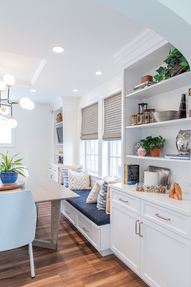 Example of a large beach style u-shaped vinyl floor and brown floor eat-in kitchen design in Philadelphia with an undermount sink, shaker cabinets, white cabinets, quartz countertops, white backsplash, marble backsplash, paneled appliances, an island and white countertops