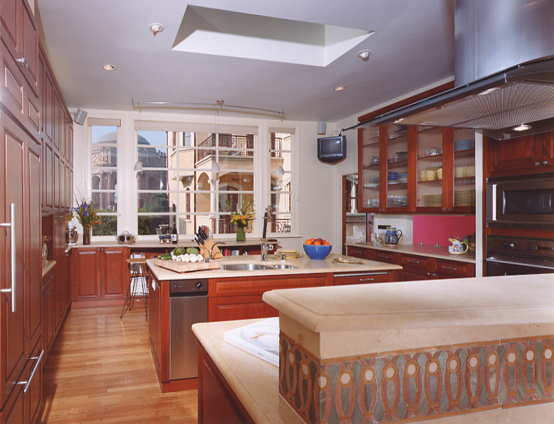 Kitchen - traditional medium tone wood floor kitchen idea in San Francisco with limestone countertops and two islands