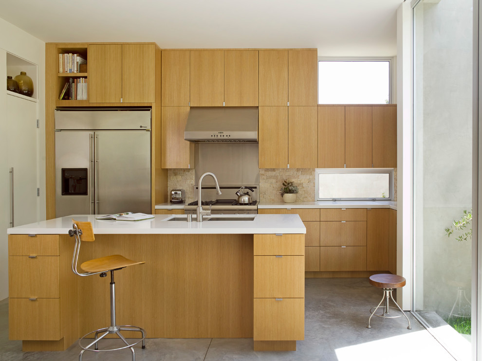 Exempel på ett mellanstort modernt kök, med en undermonterad diskho, släta luckor, skåp i mellenmörkt trä, bänkskiva i kvarts, stänkskydd i stenkakel, rostfria vitvaror, betonggolv, en köksö, beige stänkskydd och grått golv