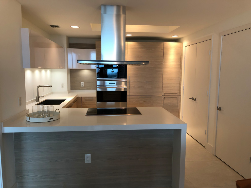 Eat-in kitchen - small modern u-shaped porcelain tile and beige floor eat-in kitchen idea in Miami with an undermount sink, flat-panel cabinets, white cabinets, quartzite countertops, stainless steel appliances, a peninsula and white countertops