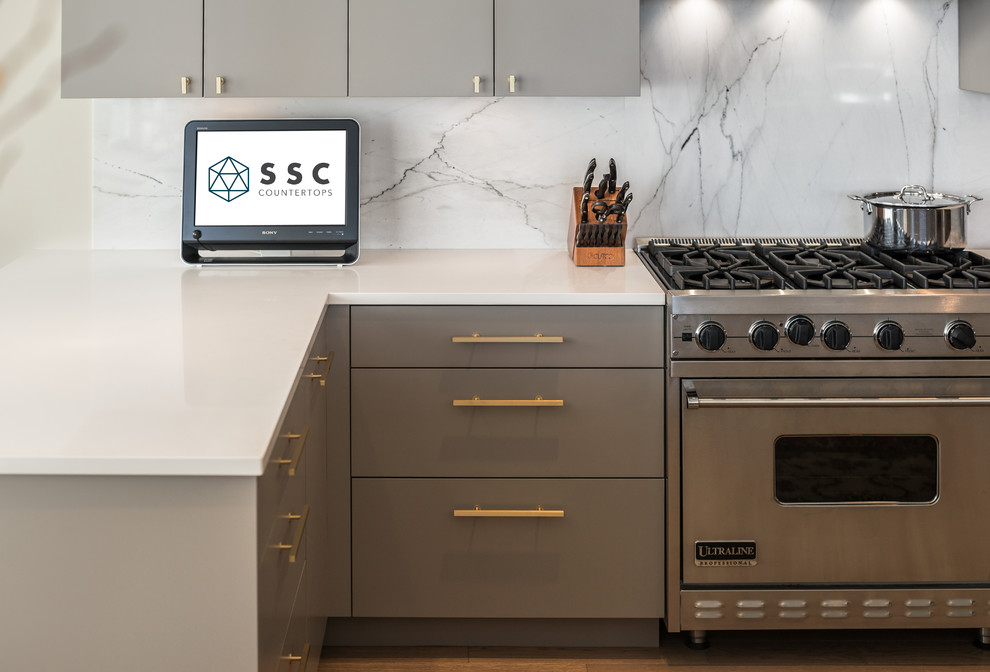 Medium sized contemporary kitchen in Vancouver with grey splashback and marble splashback.