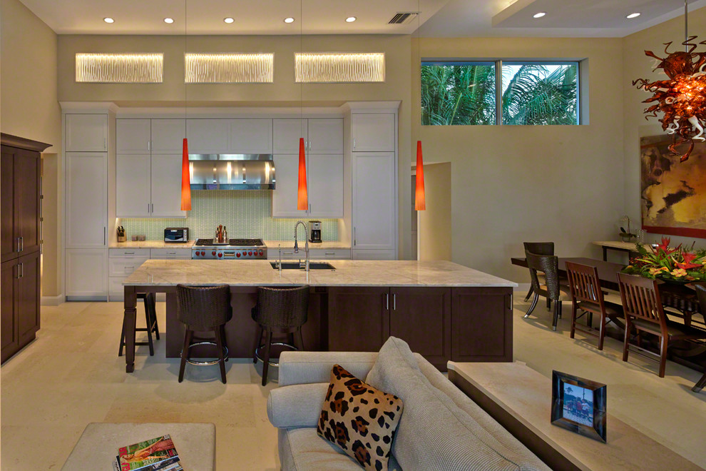 Inspiration for a mid-sized tropical single-wall travertine floor open concept kitchen remodel in Miami with shaker cabinets, dark wood cabinets, stainless steel appliances, an island, an undermount sink, marble countertops, green backsplash and glass tile backsplash