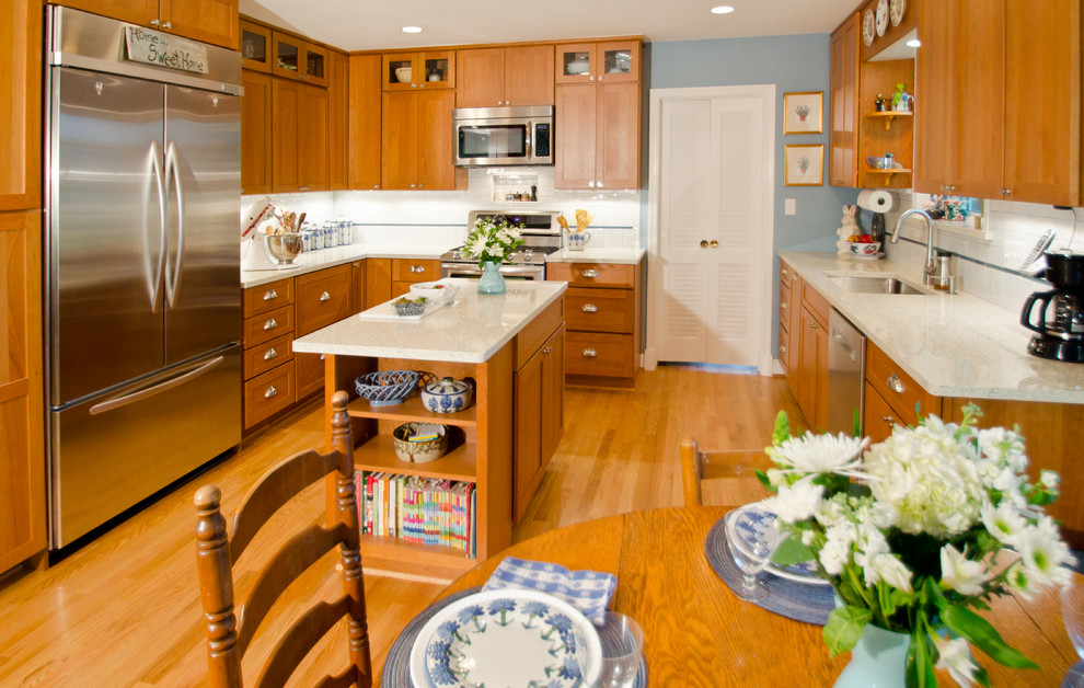 Enclosed kitchen - large traditional u-shaped light wood floor enclosed kitchen idea in DC Metro with an undermount sink, shaker cabinets, medium tone wood cabinets, quartzite countertops, white backsplash, ceramic backsplash, stainless steel appliances and an island