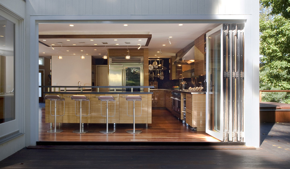 Example of a minimalist kitchen design in New York with stainless steel appliances
