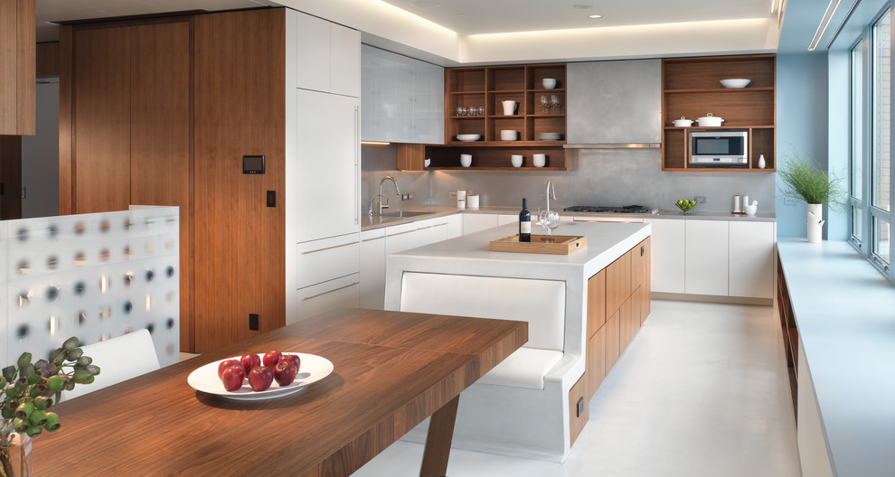 This is an example of a contemporary l-shaped kitchen/diner in San Francisco with an island, open cabinets, medium wood cabinets, concrete worktops, a single-bowl sink, grey splashback and integrated appliances.