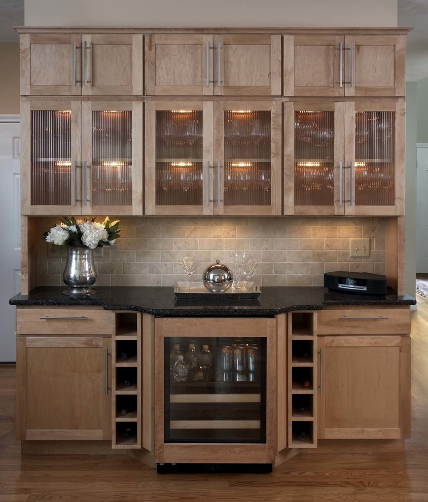 Inspiration for a large contemporary u-shaped kitchen/diner in Boston with shaker cabinets, light wood cabinets, engineered stone countertops, beige splashback, metro tiled splashback, stainless steel appliances, light hardwood flooring and a breakfast bar.