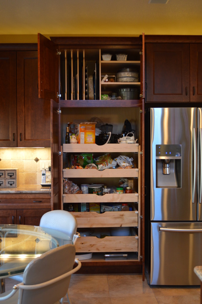 Inspiration for a small transitional u-shaped eat-in kitchen remodel in Denver with an undermount sink, recessed-panel cabinets, medium tone wood cabinets, granite countertops, beige backsplash, stone tile backsplash and stainless steel appliances