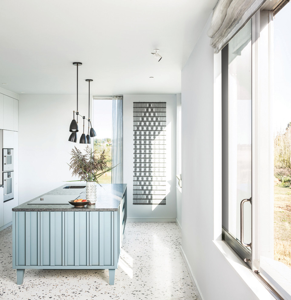 Inspiration for a medium sized contemporary kitchen in Cambridgeshire with terrazzo flooring, an island and white floors.