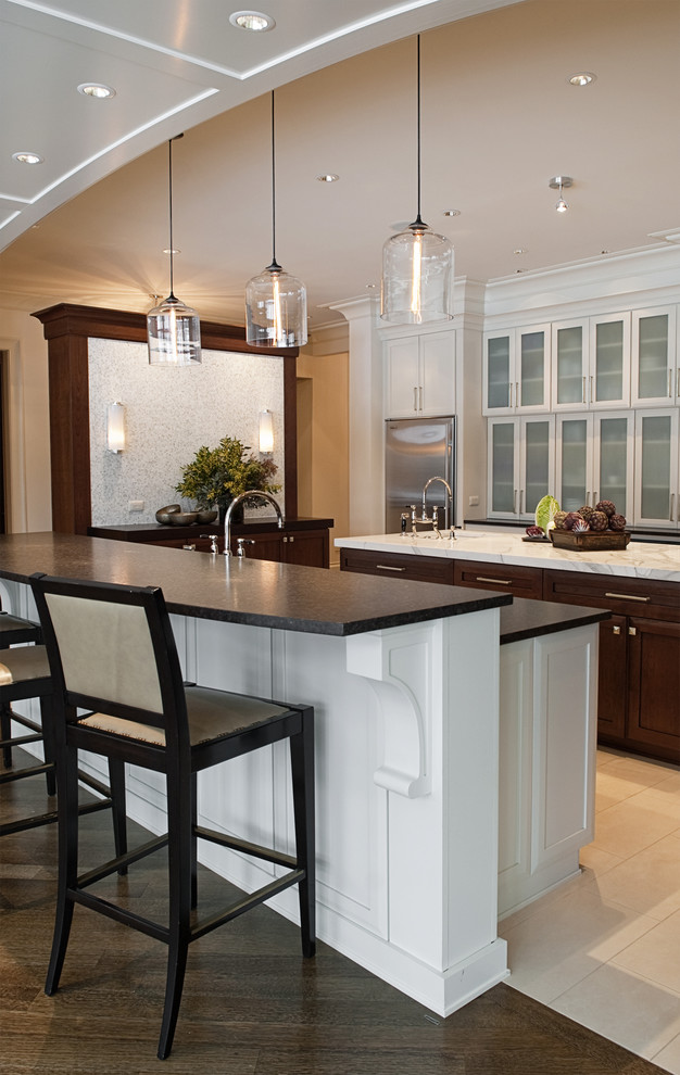 Exempel på ett modernt kök med öppen planlösning, med rostfria vitvaror, en undermonterad diskho, luckor med infälld panel, vita skåp, granitbänkskiva, stänkskydd i stenkakel och mellanmörkt trägolv