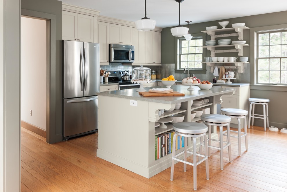 Eat-in kitchen - small cottage l-shaped medium tone wood floor eat-in kitchen idea in New York with shaker cabinets, gray cabinets, solid surface countertops, stainless steel appliances and an island