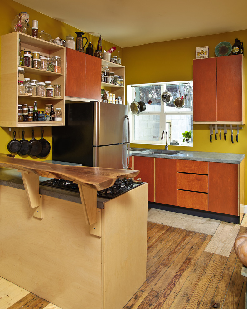 Photo of an eclectic kitchen in Philadelphia with concrete worktops, stainless steel appliances and open cabinets.