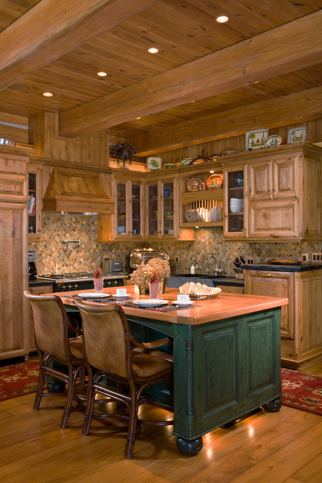 Inspiration for a mid-sized rustic l-shaped light wood floor eat-in kitchen remodel in Other with wood countertops, multicolored backsplash, an island, a double-bowl sink, raised-panel cabinets, medium tone wood cabinets, mosaic tile backsplash, stainless steel appliances and multicolored countertops