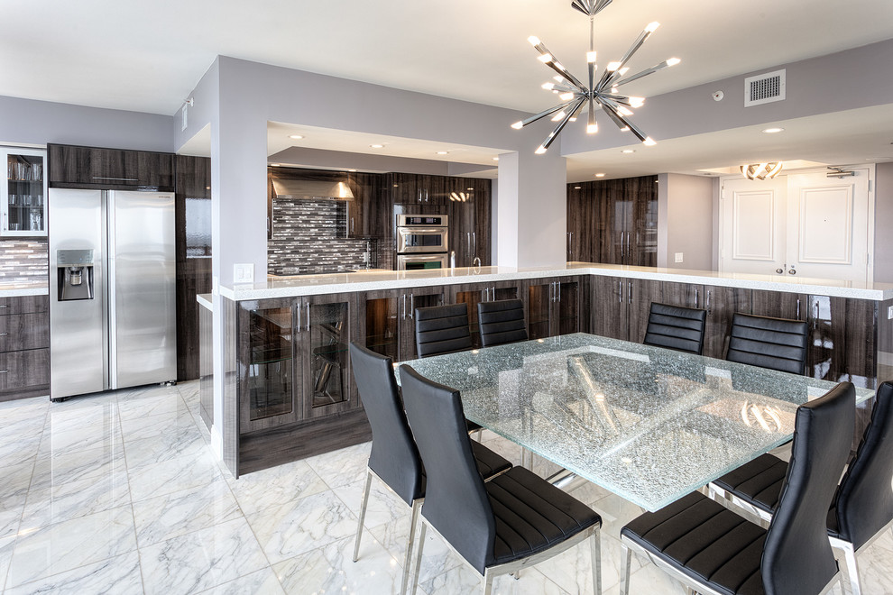Example of a minimalist marble floor eat-in kitchen design in Miami with an undermount sink, flat-panel cabinets, dark wood cabinets, quartzite countertops, metallic backsplash, stone tile backsplash and an island