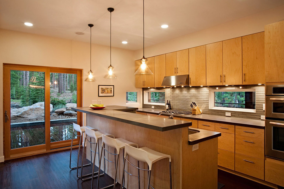 Inspiration for a contemporary kitchen remodel in Sacramento with stainless steel appliances, flat-panel cabinets, medium tone wood cabinets, quartz countertops, beige backsplash and matchstick tile backsplash