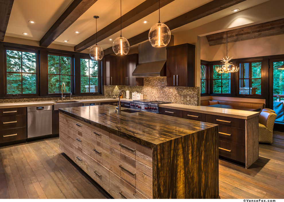 This is an example of a large rustic u-shaped open plan kitchen in Sacramento with an island, flat-panel cabinets, dark wood cabinets, granite worktops, grey splashback, mosaic tiled splashback, stainless steel appliances, a belfast sink and dark hardwood flooring.