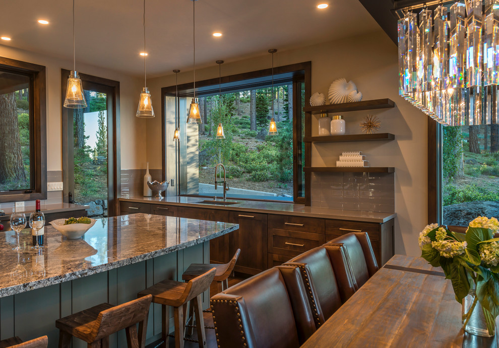 Open concept kitchen - mid-sized rustic u-shaped dark wood floor and brown floor open concept kitchen idea in Sacramento with an undermount sink, shaker cabinets, dark wood cabinets, granite countertops, gray backsplash, glass tile backsplash, paneled appliances and an island