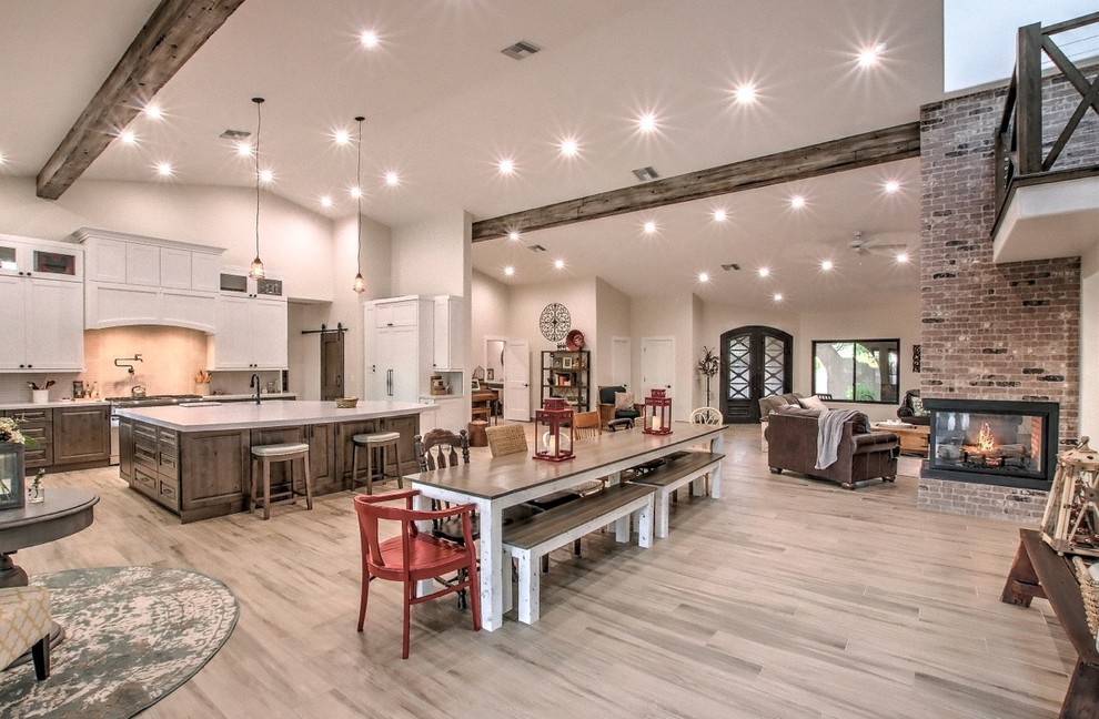 Inspiration for an expansive farmhouse l-shaped open plan kitchen in Phoenix with a belfast sink, raised-panel cabinets, medium wood cabinets, engineered stone countertops, white splashback, mosaic tiled splashback, integrated appliances, medium hardwood flooring, an island, brown floors and white worktops.