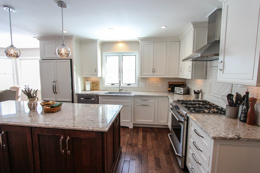 Example of a mid-sized classic l-shaped eat-in kitchen design in Cincinnati with an undermount sink, flat-panel cabinets, white cabinets, granite countertops, white backsplash, subway tile backsplash and stainless steel appliances