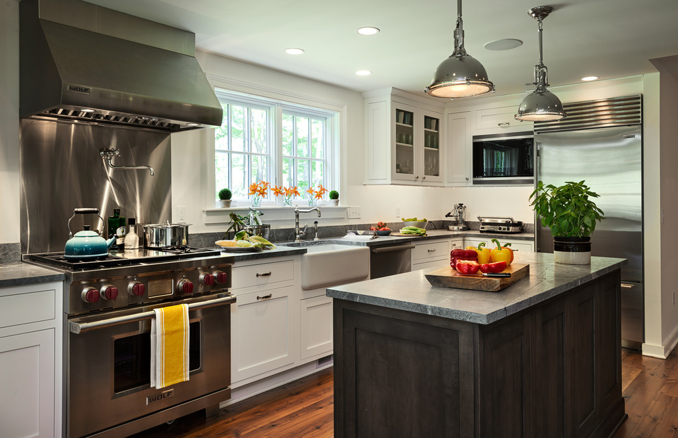 Farmhouse eat-in kitchen photo in New York with a farmhouse sink, shaker cabinets, white cabinets, metallic backsplash, stainless steel appliances, granite countertops and metal backsplash