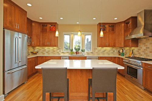 U-Shaped Kitchen Cabinets in warm wood finish with central island and stainless steel appliances