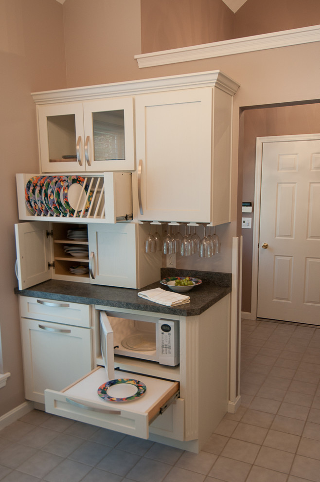 Example of a small classic ceramic tile enclosed kitchen design in Cincinnati with shaker cabinets, white cabinets, laminate countertops, white appliances and no island