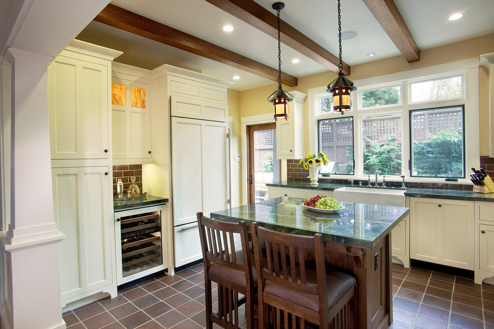 Example of a large arts and crafts u-shaped terra-cotta tile and brown floor eat-in kitchen design in San Diego with a farmhouse sink, raised-panel cabinets, white cabinets, marble countertops, brown backsplash, subway tile backsplash, stainless steel appliances and an island
