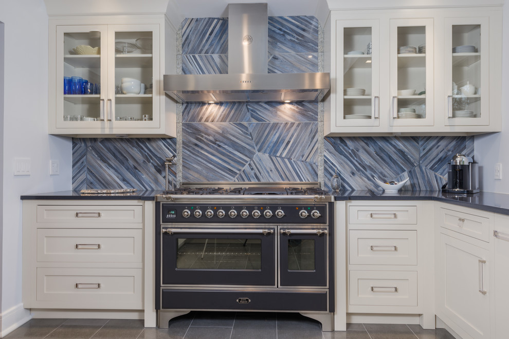 Inspiration for a mid-sized contemporary l-shaped porcelain tile eat-in kitchen remodel in New York with an undermount sink, recessed-panel cabinets, beige cabinets, quartz countertops, blue backsplash, porcelain backsplash, stainless steel appliances and a peninsula