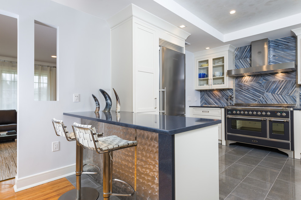 Eat-in kitchen - mid-sized contemporary l-shaped porcelain tile eat-in kitchen idea in New York with an undermount sink, recessed-panel cabinets, beige cabinets, quartz countertops, blue backsplash, porcelain backsplash, stainless steel appliances and a peninsula