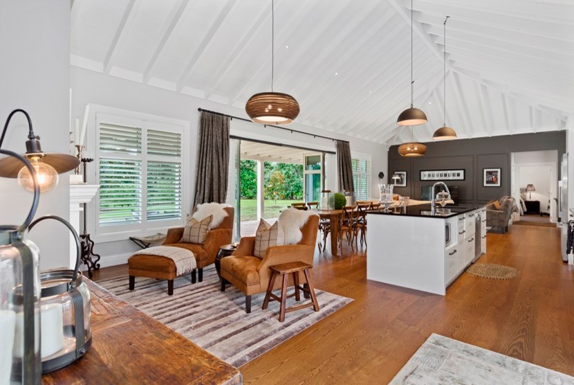 Rustic kitchen in Auckland with light hardwood flooring and brown floors.