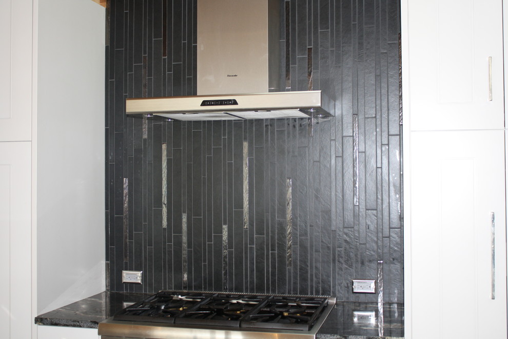 Imagen de cocina comedor lineal contemporánea pequeña con salpicadero negro y salpicadero de azulejos de porcelana