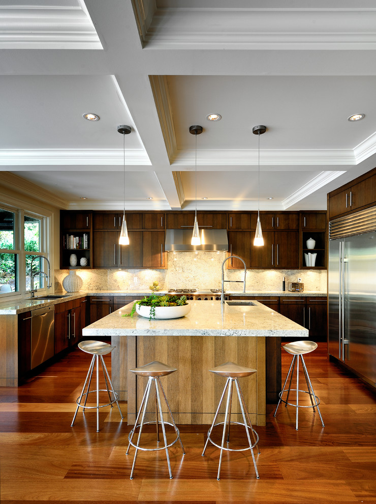 Trendy u-shaped kitchen photo in Vancouver with flat-panel cabinets, dark wood cabinets, white backsplash, stone slab backsplash and stainless steel appliances