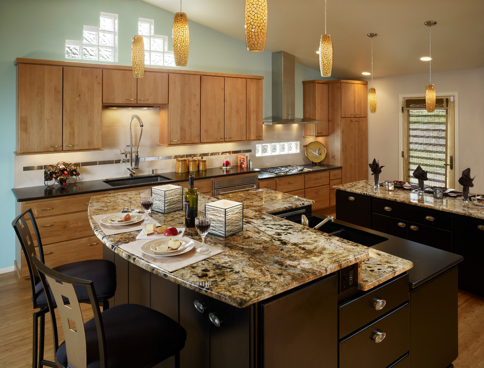 Eat-in kitchen - large traditional single-wall bamboo floor and beige floor eat-in kitchen idea in Denver with an undermount sink, flat-panel cabinets, light wood cabinets, granite countertops, beige backsplash, porcelain backsplash, stainless steel appliances and two islands