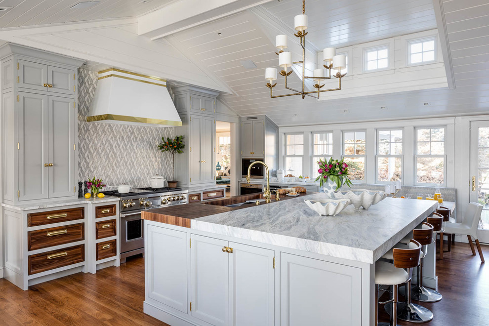 Beach style medium tone wood floor and brown floor eat-in kitchen photo in Providence with an undermount sink, recessed-panel cabinets, gray cabinets, multicolored backsplash, stainless steel appliances, an island and white countertops