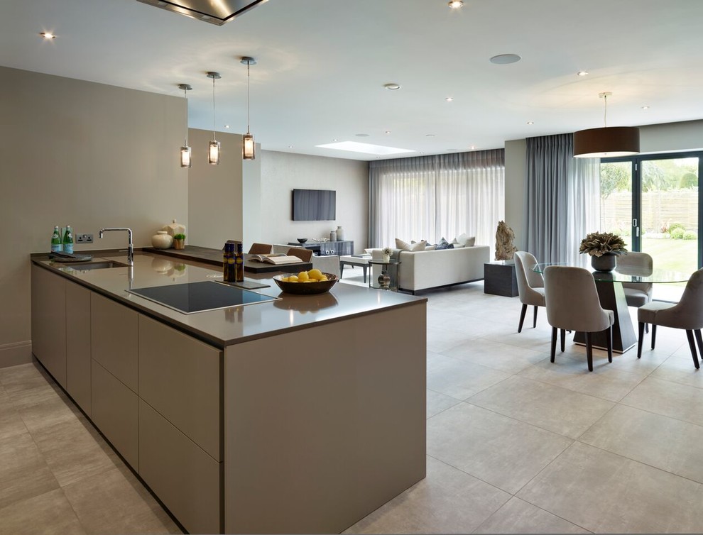 Design ideas for a contemporary kitchen in London with an integrated sink, flat-panel cabinets, composite countertops, stainless steel appliances and an island.