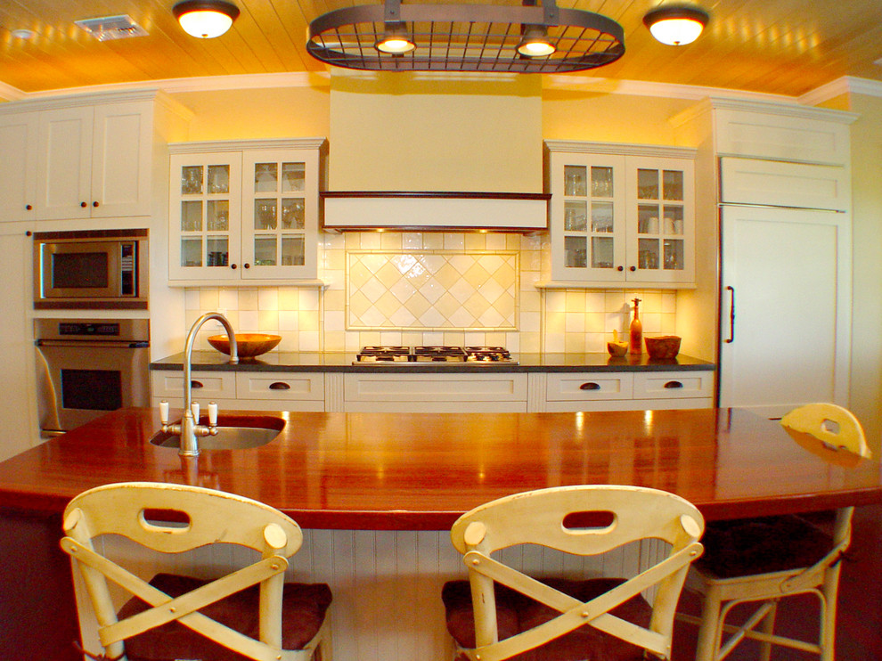 Inspiration for a world-inspired kitchen in Hawaii with wood worktops and yellow splashback.