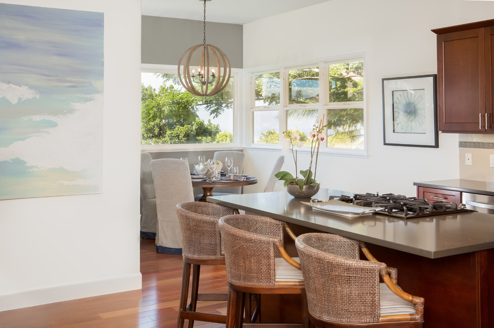 Small beach style l-shaped dark wood floor open concept kitchen photo in Hawaii with shaker cabinets, dark wood cabinets, quartz countertops, beige backsplash, porcelain backsplash, stainless steel appliances and an island