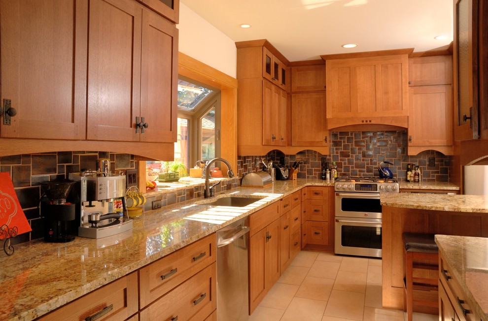 Large arts and crafts l-shaped porcelain tile eat-in kitchen photo in Minneapolis with an undermount sink, shaker cabinets, medium tone wood cabinets, granite countertops, brown backsplash, ceramic backsplash and stainless steel appliances