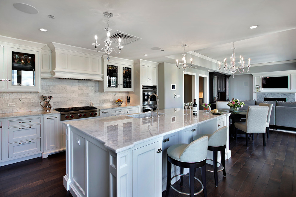 Inspiration for a timeless open concept kitchen remodel in Chicago with an integrated sink, glass-front cabinets, white cabinets, marble countertops and white backsplash