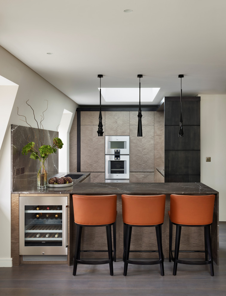 Exempel på ett mellanstort modernt brun brunt u-kök, med släta luckor, marmorbänkskiva, en halv köksö, en nedsänkt diskho, beige skåp, brunt stänkskydd, integrerade vitvaror och grått golv