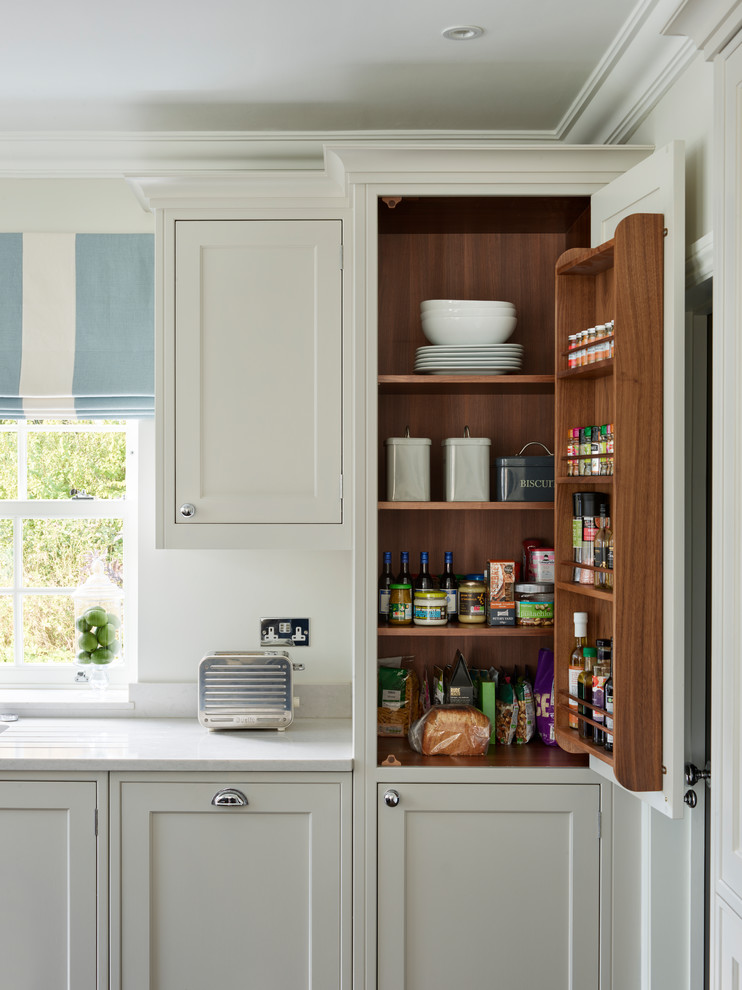 Large transitional kitchen photo in Buckinghamshire with shaker cabinets, white backsplash, gray countertops and beige cabinets