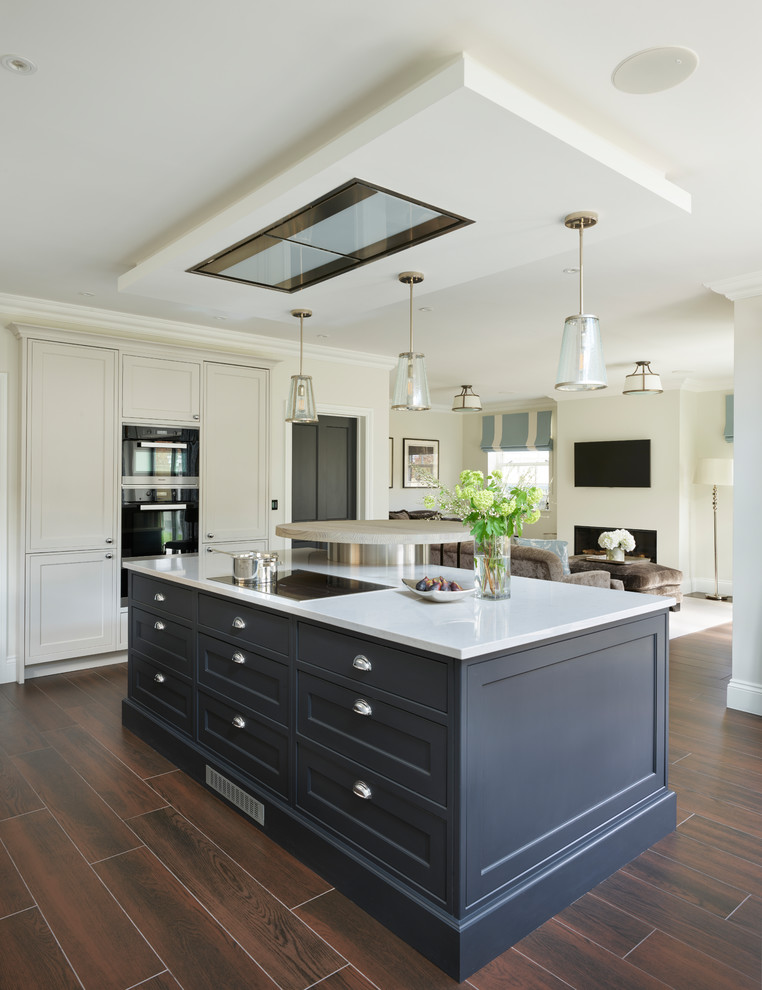 Photo of a large traditional open plan kitchen in Buckinghamshire with shaker cabinets and an island.